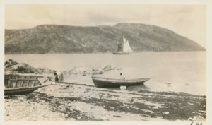 Image of Boats along beach, and schooner under sail